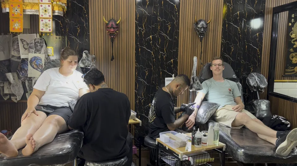 Two clients having tattoo sessions inside the Lifewell studio